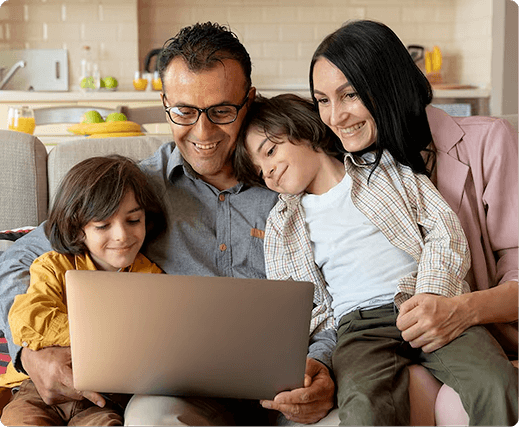 Family enjoying time together while using a laptop, reflecting the importance of health insurance for home service professionals and their families.