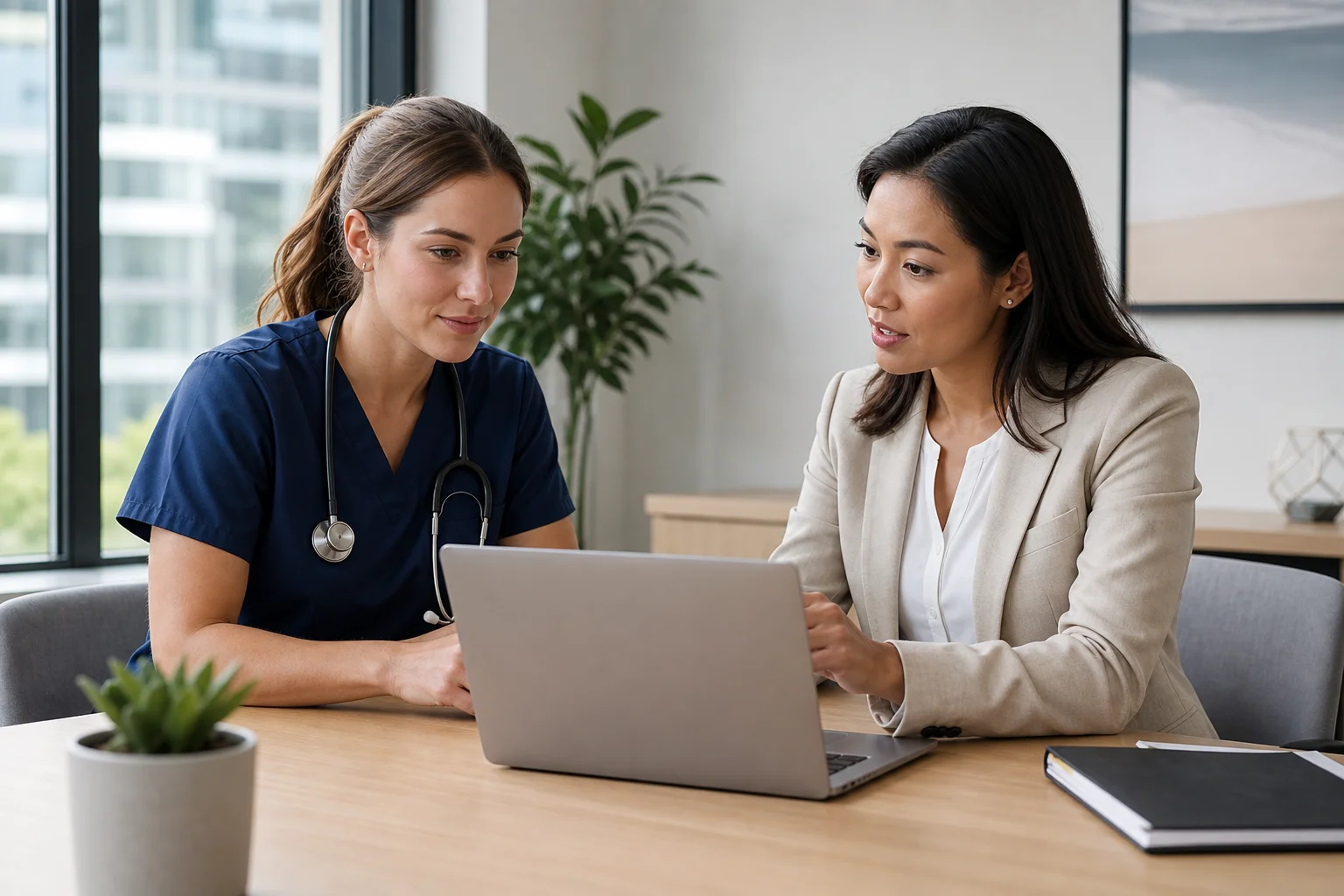 A travel nurse and health insurance advisor reviewing coverage options side by side on a laptop at a bright office desk, photorealistic, natural light