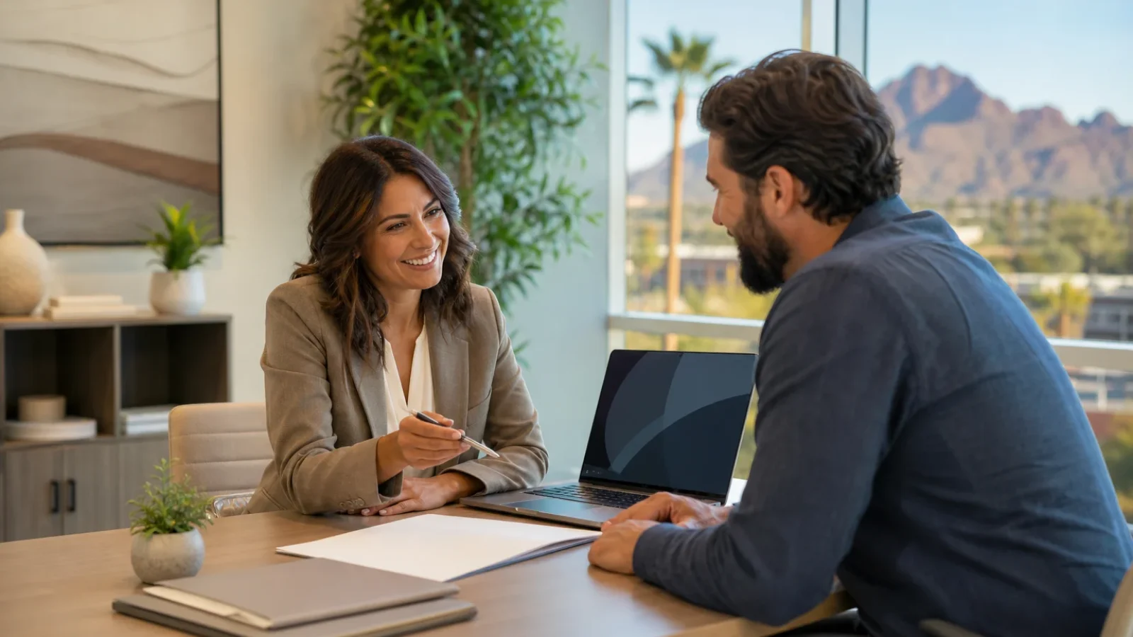 Health insurance advisor meeting one-on-one with a self-employed Arizona professional about open enrollment options