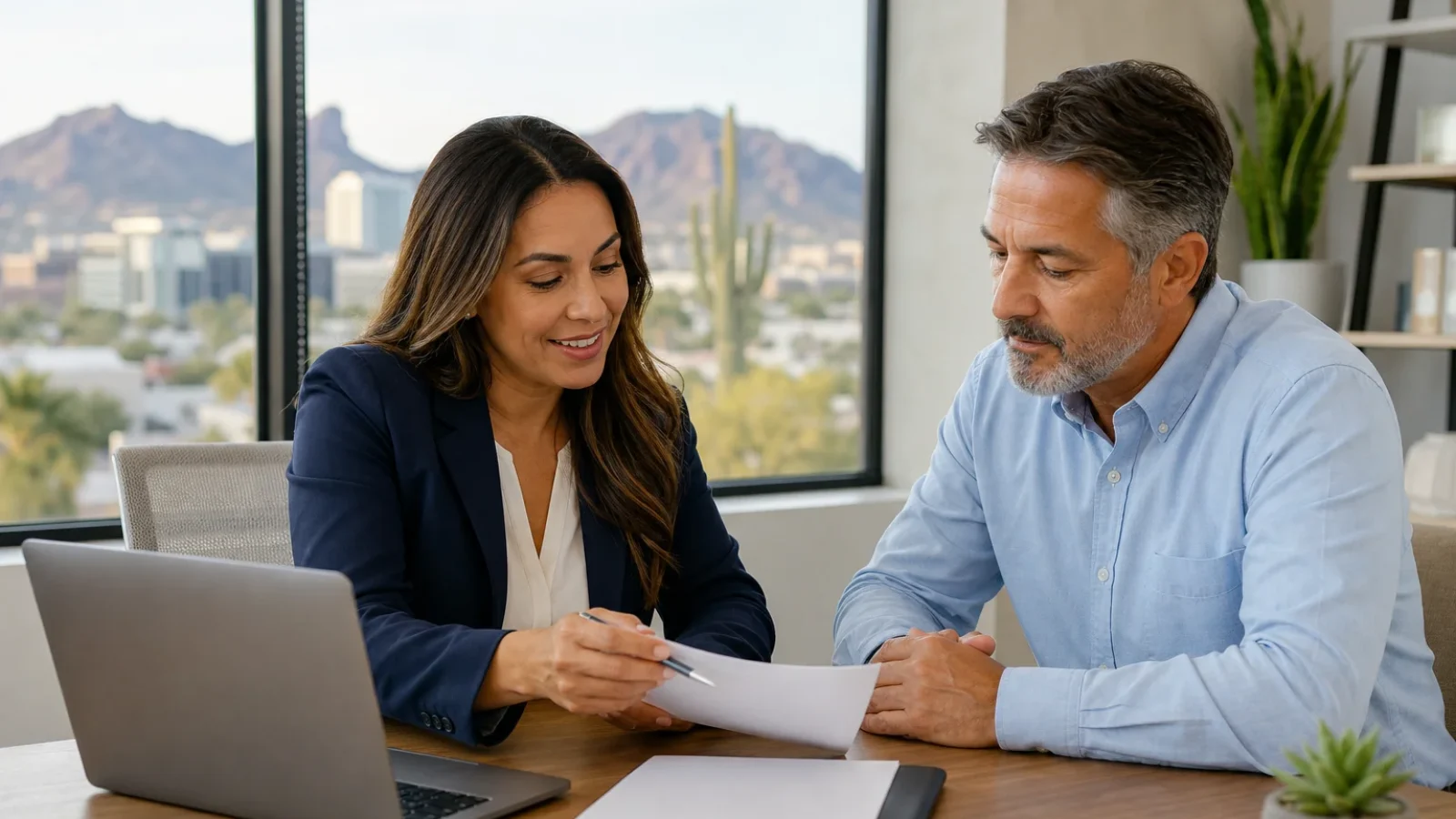 Health insurance advisor helping a client check Banner, HonorHealth or Mayo network coverage on a laptop